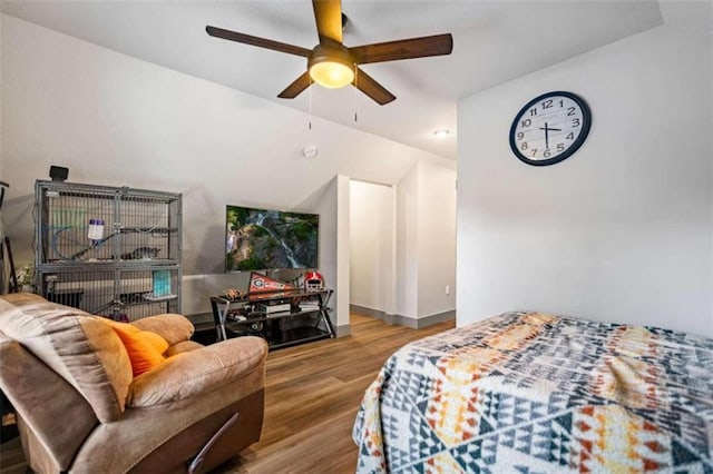 bedroom featuring hardwood / wood-style floors, vaulted ceiling, and ceiling fan