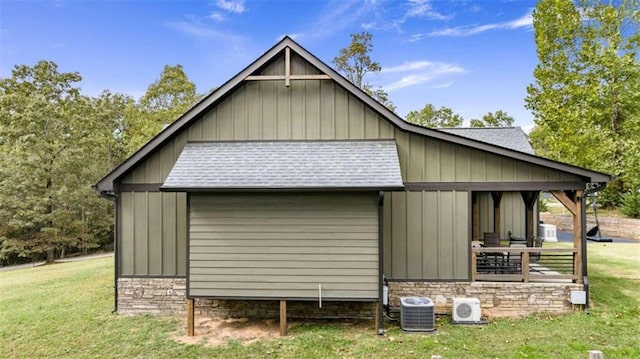 view of side of home featuring a lawn and central AC unit