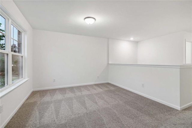 empty room with carpet floors, recessed lighting, and baseboards