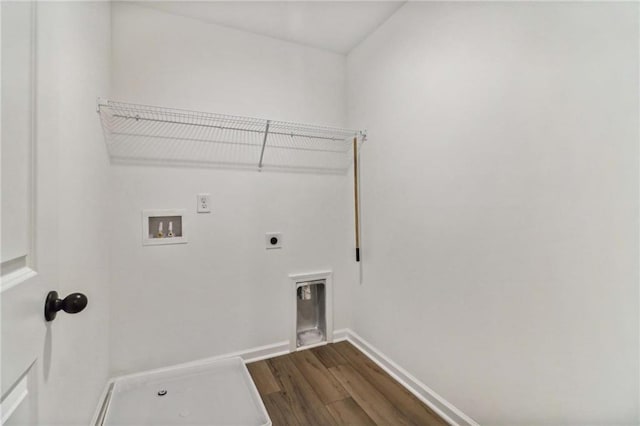 clothes washing area with dark wood-style floors, washer hookup, hookup for an electric dryer, laundry area, and baseboards