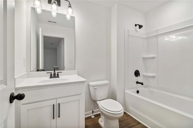 full bathroom with shower / bath combination, visible vents, toilet, vanity, and wood finished floors