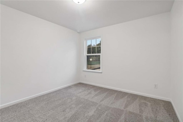 spare room with carpet flooring and baseboards