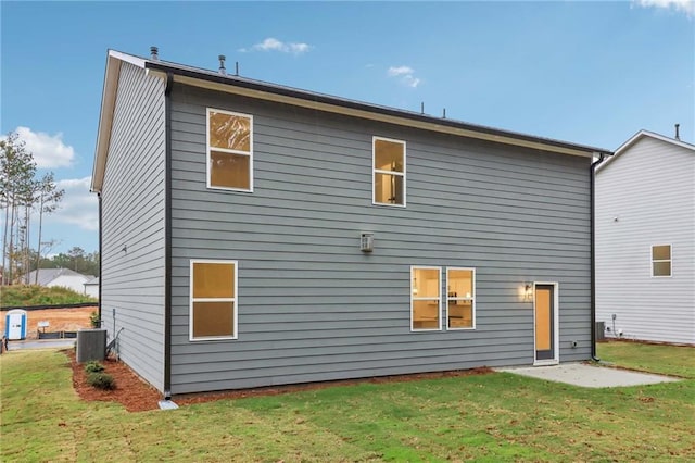 rear view of property with a patio area, a lawn, and central AC unit