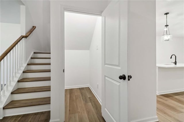 stairway with baseboards and wood finished floors