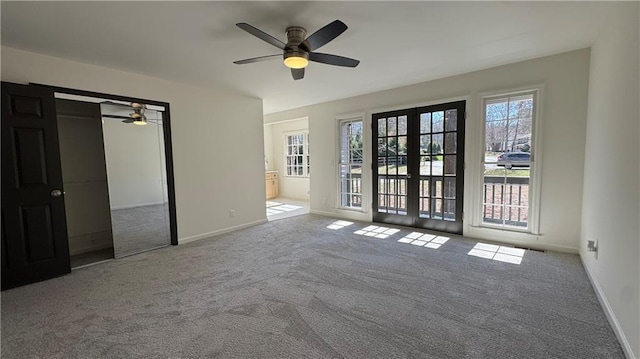 empty room with french doors, baseboards, and carpet