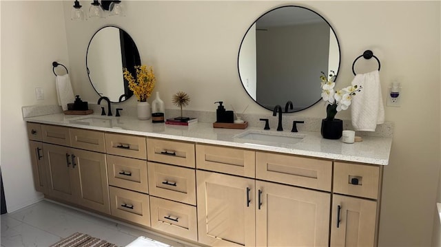 bathroom with a sink, marble finish floor, and double vanity