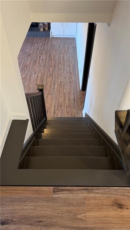 stairway with wood finished floors