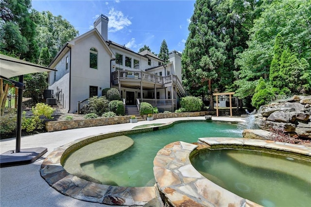 7920 Tintern Trce, Duluth, GA 30097 - view of swimming pool with stairway, central AC, a pool with connected hot tub, and a patio area