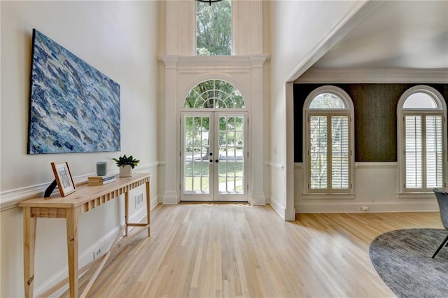 7920 Tintern Trce, Duluth, GA 30097 - foyer featuring french doors, wood finished floors, wainscoting, and a high ceiling