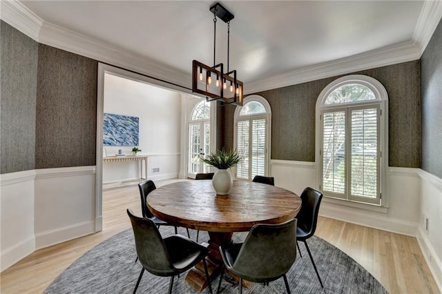 7920 Tintern Trce, Duluth, GA 30097 - dining area with wallpapered walls, wood finished floors, crown molding, a wainscoted wall, and a chandelier