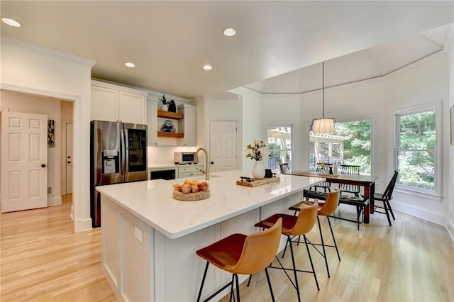 7920 Tintern Trce, Duluth, GA 30097 - kitchen with stainless steel fridge, open shelves, light wood-style floors, recessed lighting, and a sink