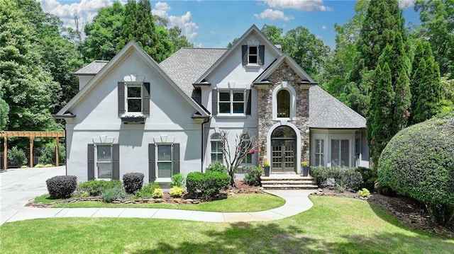7920 Tintern Trce, Duluth, GA 30097 - view of front of property featuring stucco siding, stone siding, a front lawn, and a shingled roof