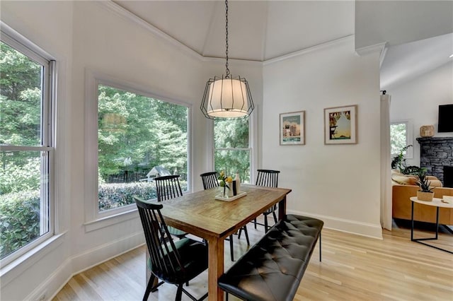 7920 Tintern Trce, Duluth, GA 30097 - dining area featuring ornamental molding, baseboards, healthy amount of natural light, light wood-type flooring, and high vaulted ceiling