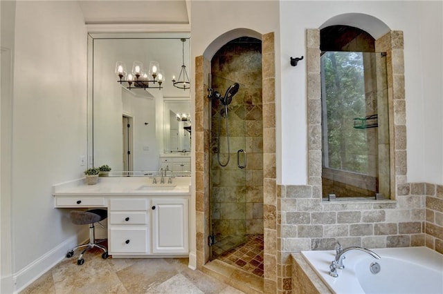 7920 Tintern Trce, Duluth, GA 30097 - bathroom featuring a bath, a stall shower, vanity, baseboards, and a chandelier