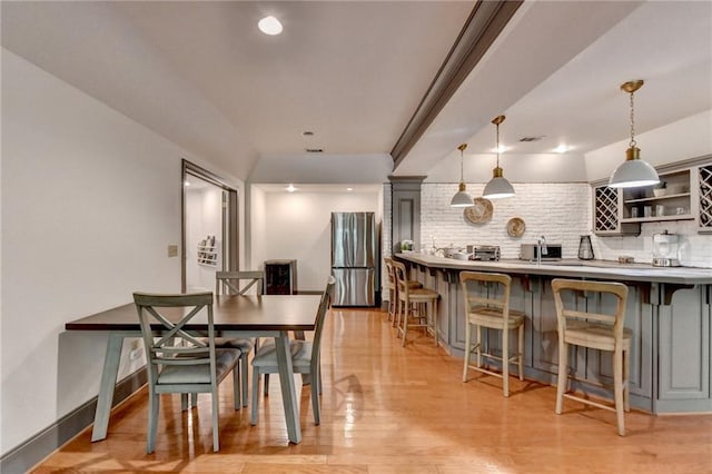 7920 Tintern Trce, Duluth, GA 30097 - dining room with light wood-style flooring and wet bar