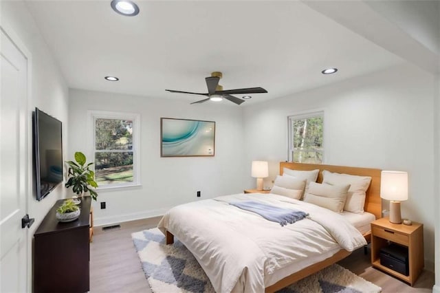 bedroom featuring light wood-style floors, baseboards, visible vents, and recessed lighting