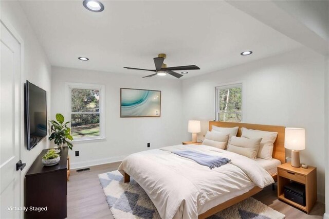 bedroom with light wood-style floors, baseboards, visible vents, and recessed lighting