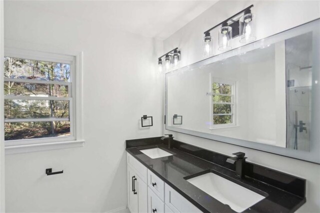 full bath with a sink and double vanity