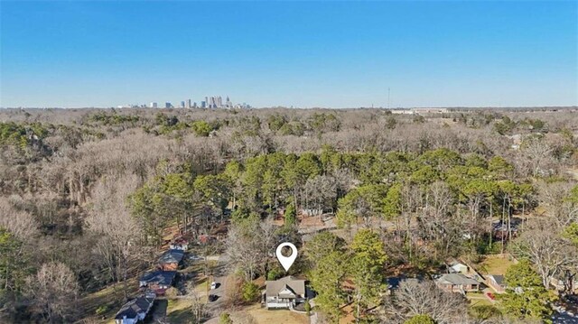 drone / aerial view featuring a wooded view