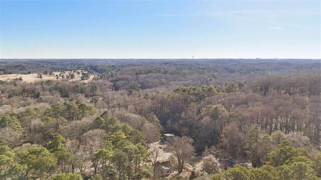 birds eye view of property featuring a view of trees