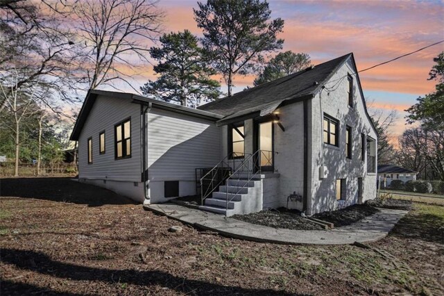 property exterior at dusk featuring fence