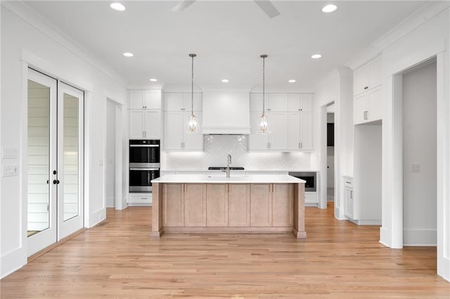 326 Reese Way, Ball Ground, GA 30107 - kitchen featuring double oven, light countertops, decorative backsplash, light wood finished floors, and white cabinets