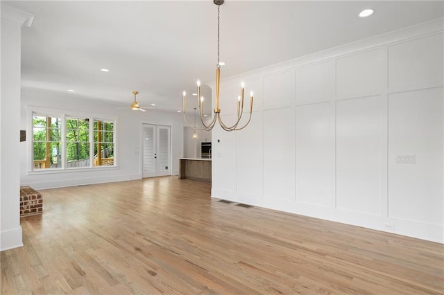 326 Reese Way, Ball Ground, GA 30107 - unfurnished living room with a decorative wall, light wood-type flooring, ceiling fan, recessed lighting, and a chandelier