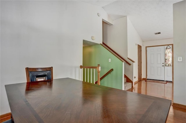 dining room with vaulted ceiling and light wood-type flooring