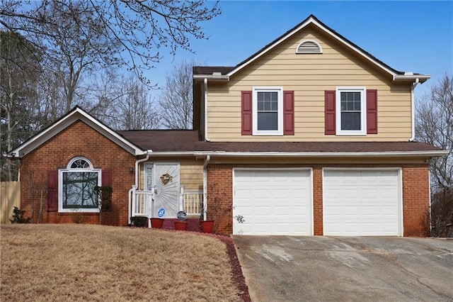 view of front of property with brick siding, driveway, a front yard, and a garage