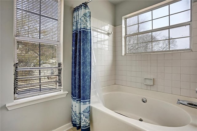 bathroom featuring shower / tub combo and a wealth of natural light