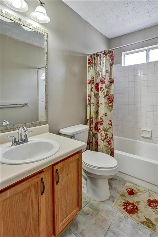 full bathroom featuring vanity, toilet, a textured ceiling, and shower / bath combo with shower curtain