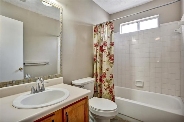 full bathroom with vanity, shower / bath combination with curtain, and toilet