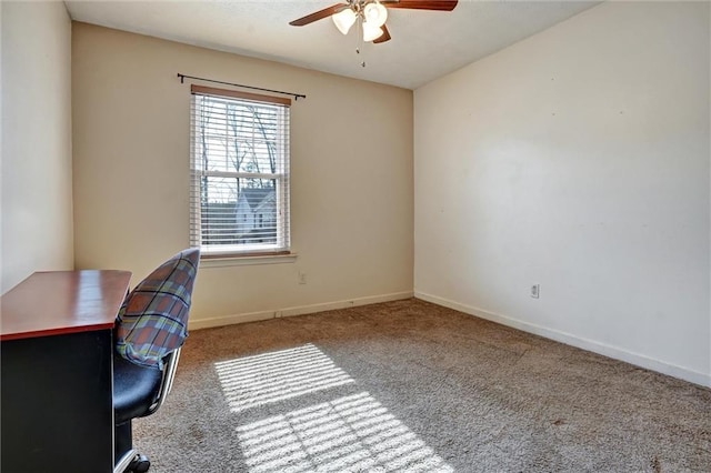 carpeted office space featuring ceiling fan