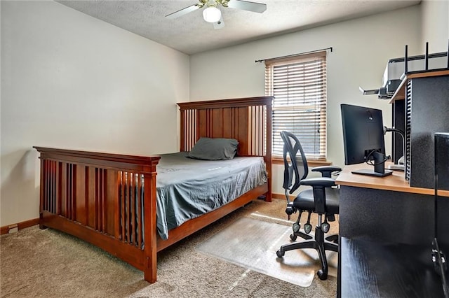 carpeted bedroom featuring ceiling fan and a textured ceiling