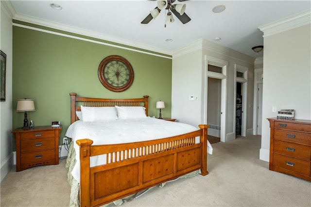 carpeted bedroom featuring ornamental molding and ceiling fan