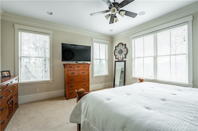 bedroom featuring ceiling fan, light carpet, and multiple windows