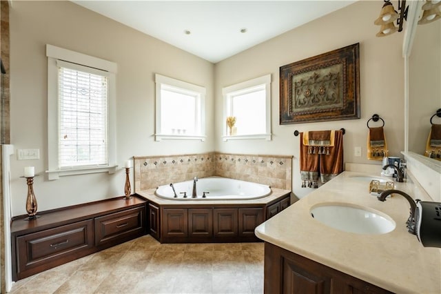 bathroom featuring vanity, a wealth of natural light, and a bathtub