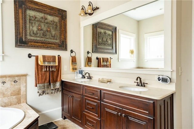 bathroom with vanity, tile patterned flooring, and a tub