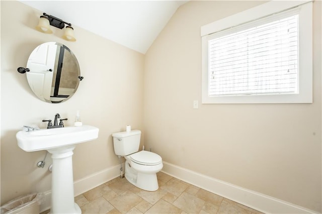 bathroom with lofted ceiling and toilet