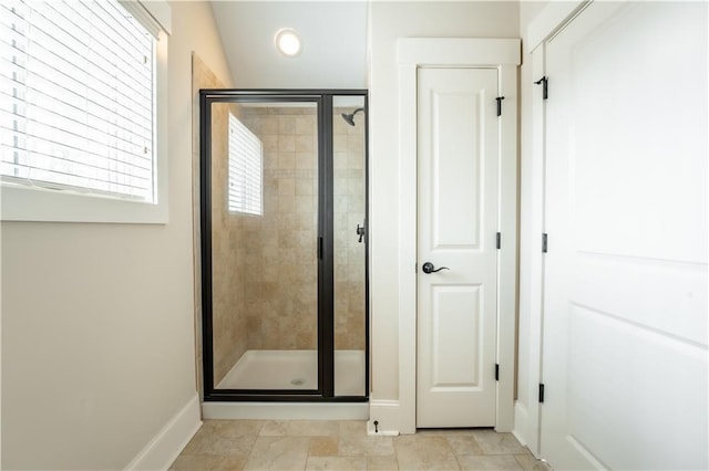 bathroom with vaulted ceiling and a shower with door