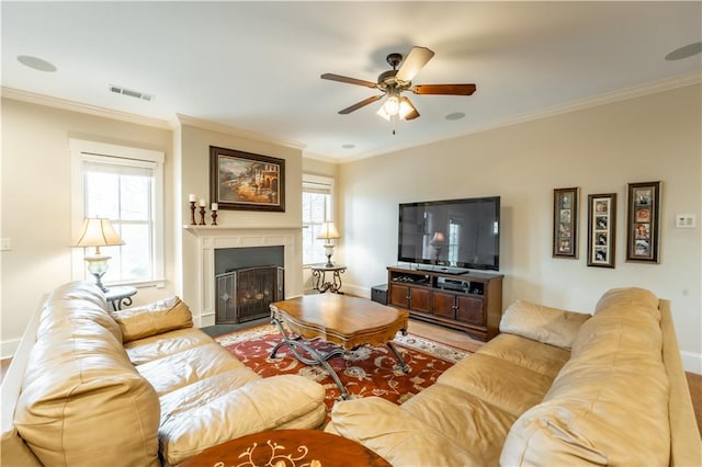 living room featuring ornamental molding and ceiling fan