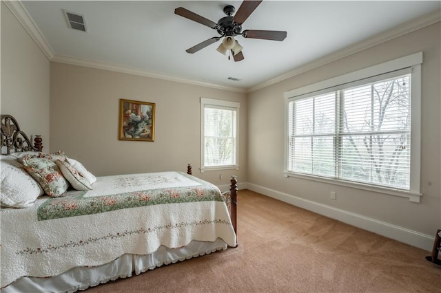 carpeted bedroom with ornamental molding and ceiling fan