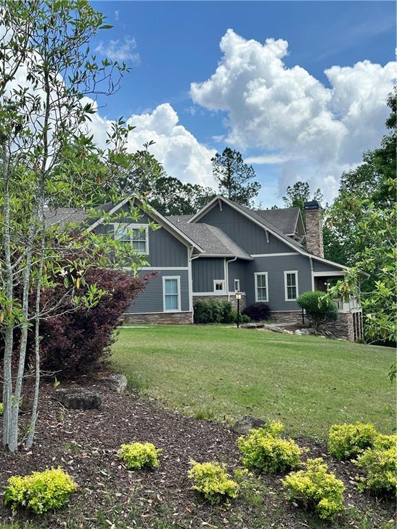 rear view of property featuring a lawn