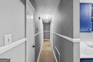 corridor featuring wood finished floors