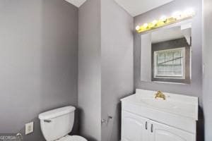 bathroom featuring toilet and vanity