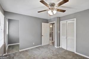 unfurnished bedroom with carpet, baseboards, and a closet