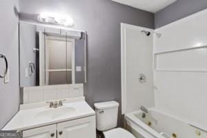 full bath featuring washtub / shower combination, vanity, and toilet