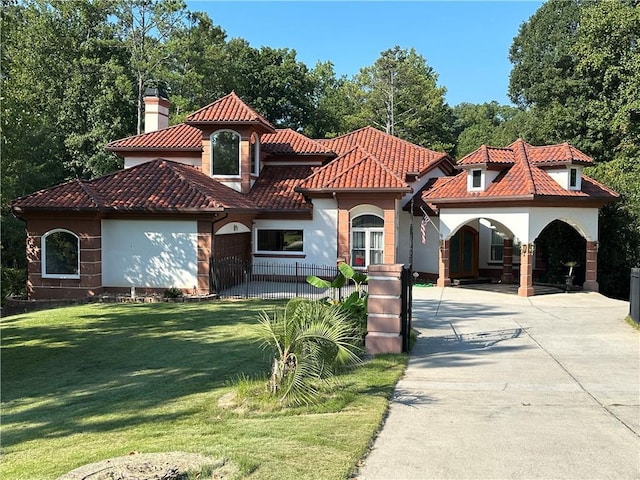 mediterranean / spanish-style home featuring a front lawn