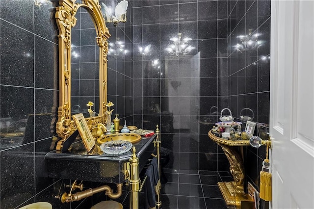 bathroom featuring vanity and tile walls