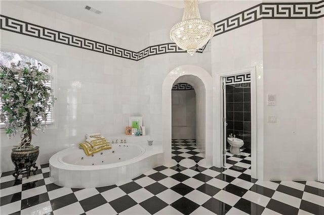 bathroom featuring a tub to relax in, a bidet, tile walls, and an inviting chandelier